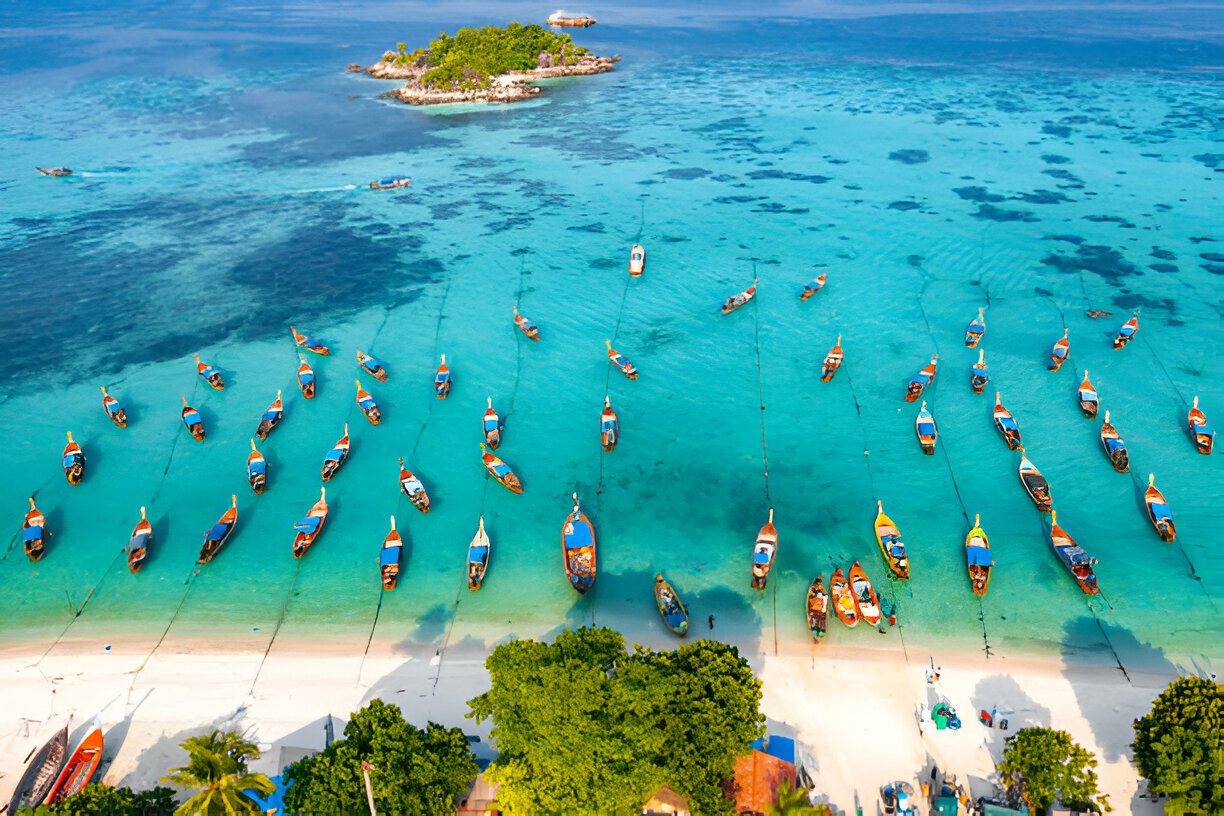 Sunrise beach with long tail boats in Koh Lipe